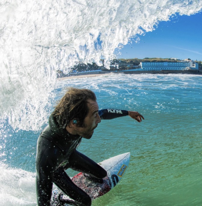 Surfer riding inside a barrel wave along the Ericeira coastline