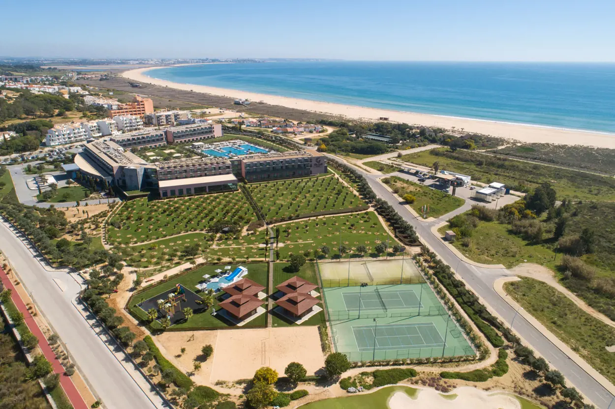 Aerial view of Vila Galé resort with tennis courts and Atlantic coastline